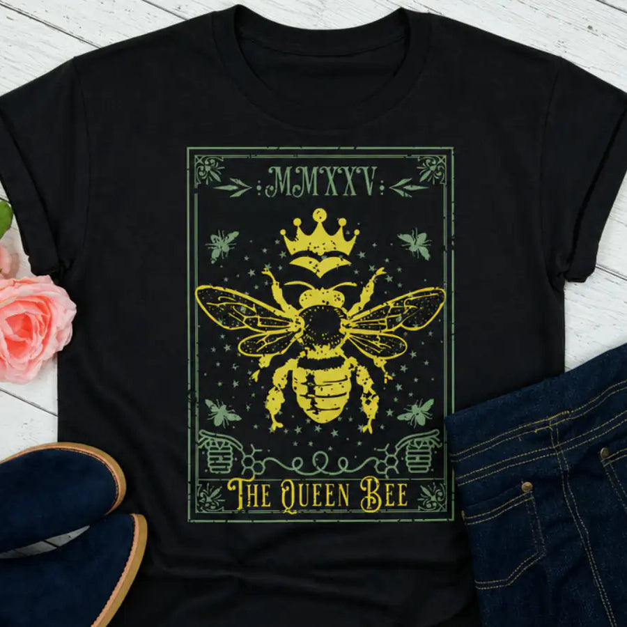 Queen Bee t-shirt on a wood plank bacground with roses and shoes