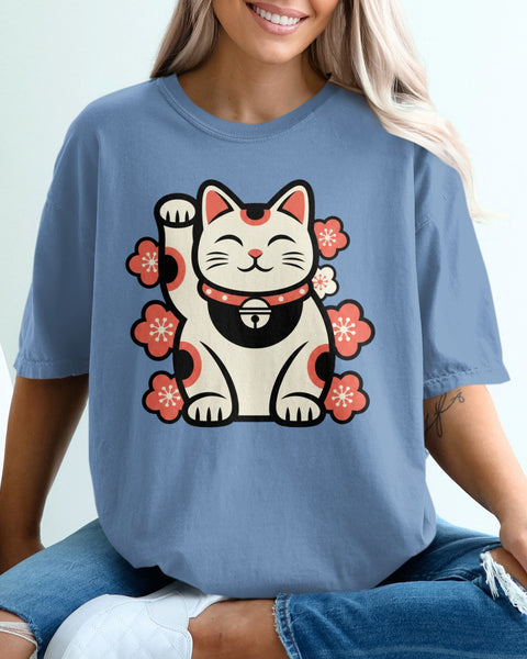 Blue t-shirt with a white maneki-neko cat and pink cherry blossoms.