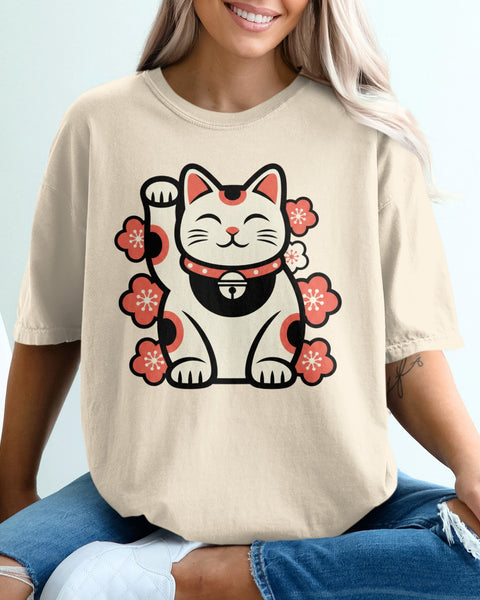 Maneki-neko cat with cherry blossoms on a light beige t-shirt.
