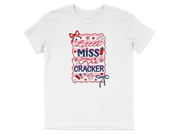 White t-shirt with "Little Miss Fire Cracker" text and patriotic graphics.