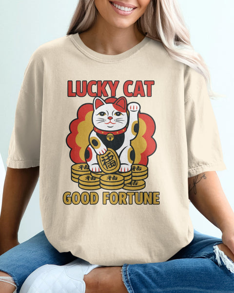 Cream t-shirt with red and gold lucky cat graphic and "GOOD FORTUNE" text.