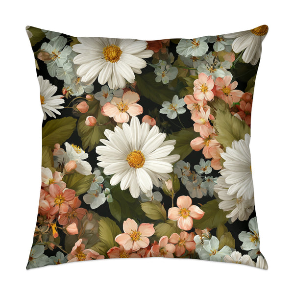Pillow with a dark background and a vibrant floral pattern of daisies and other flowers.