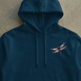 Navy blue hooded sweatshirt with a detailed embroidered dragonfly on the left chest. 