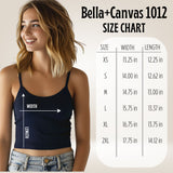 Woman wearing a navy tank top with a size chart on a beige background