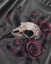 Close-up of a dark gray t-shirt featuring a detailed graphic print of a bird skull surrounded by dark purple roses and feathers.