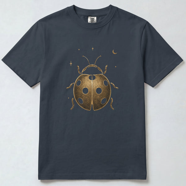 A dark charcoal gray short-sleeve t-shirt with a metallic gold ladybug graphic and small stars and crescent moon on the front, displayed flat against a light gray background.