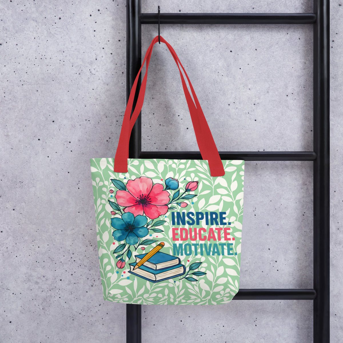 Tote bag with floral design and text 'Inspire. Educate. Motivate.' hanging on a black metal rack.