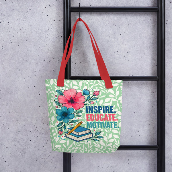 Tote bag with floral design and text 'Inspire. Educate. Motivate.' hanging on a black metal rack.