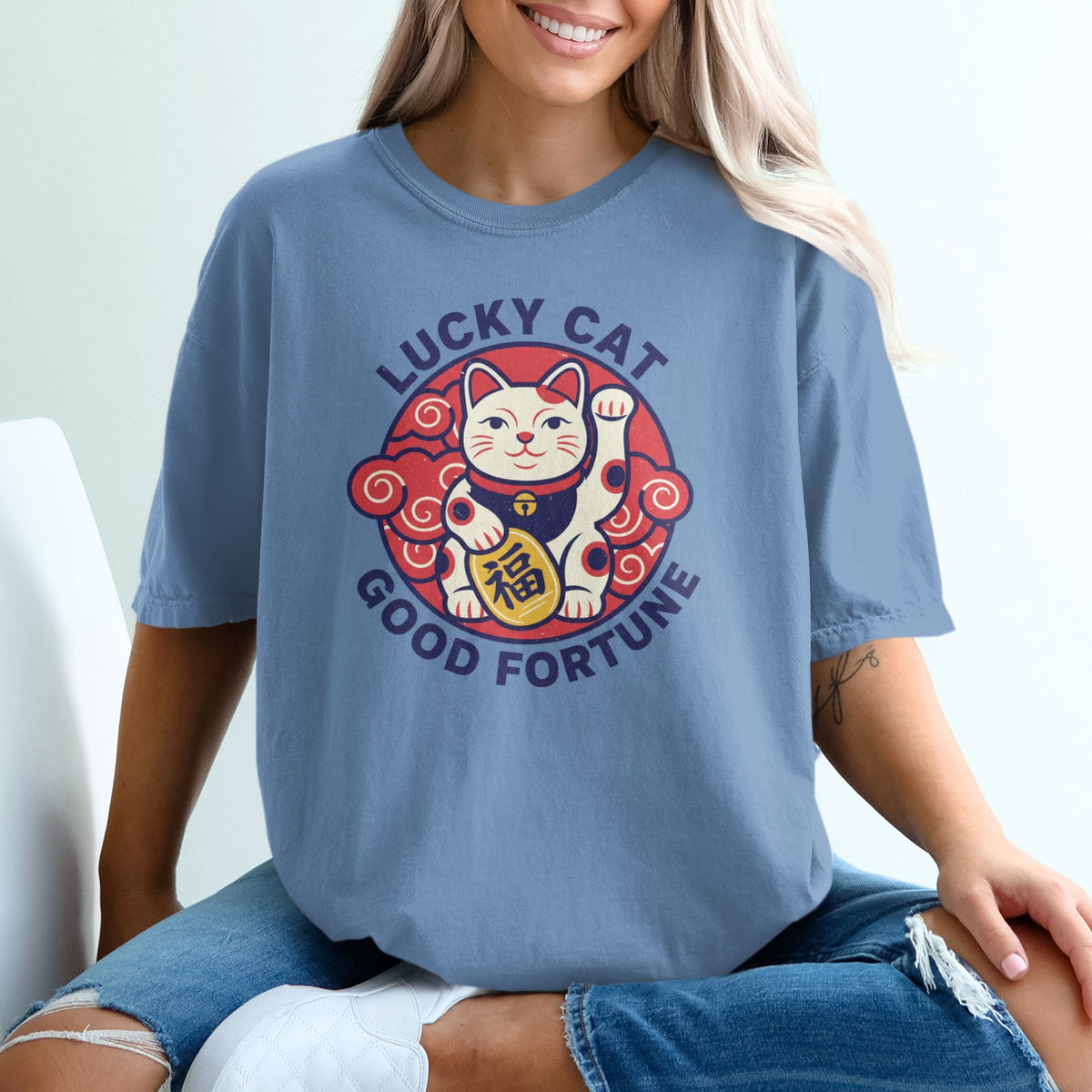 Blue t-shirt with a circular "Lucky Cat" graphic featuring a waving cat and Japanese characters.