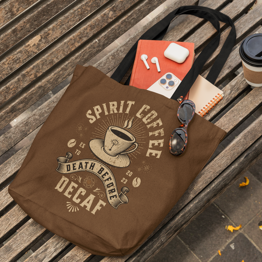 Brown tote bag with black handles - 'Spirit Coffee' design on a wooden bench.