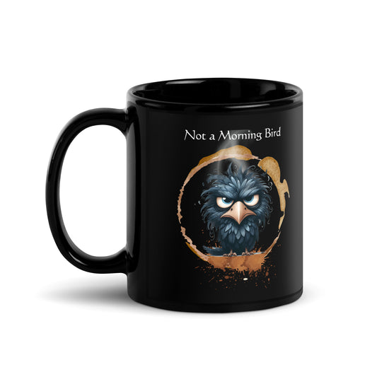 Glossy black ceramic coffee mug with a grumpy bluebird illustration and “Not a Morning Bird” text. Funny gift for night owls and caffeine lovers.Product mockup
