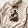 Beige hoodie with a horse design on the back against a white background