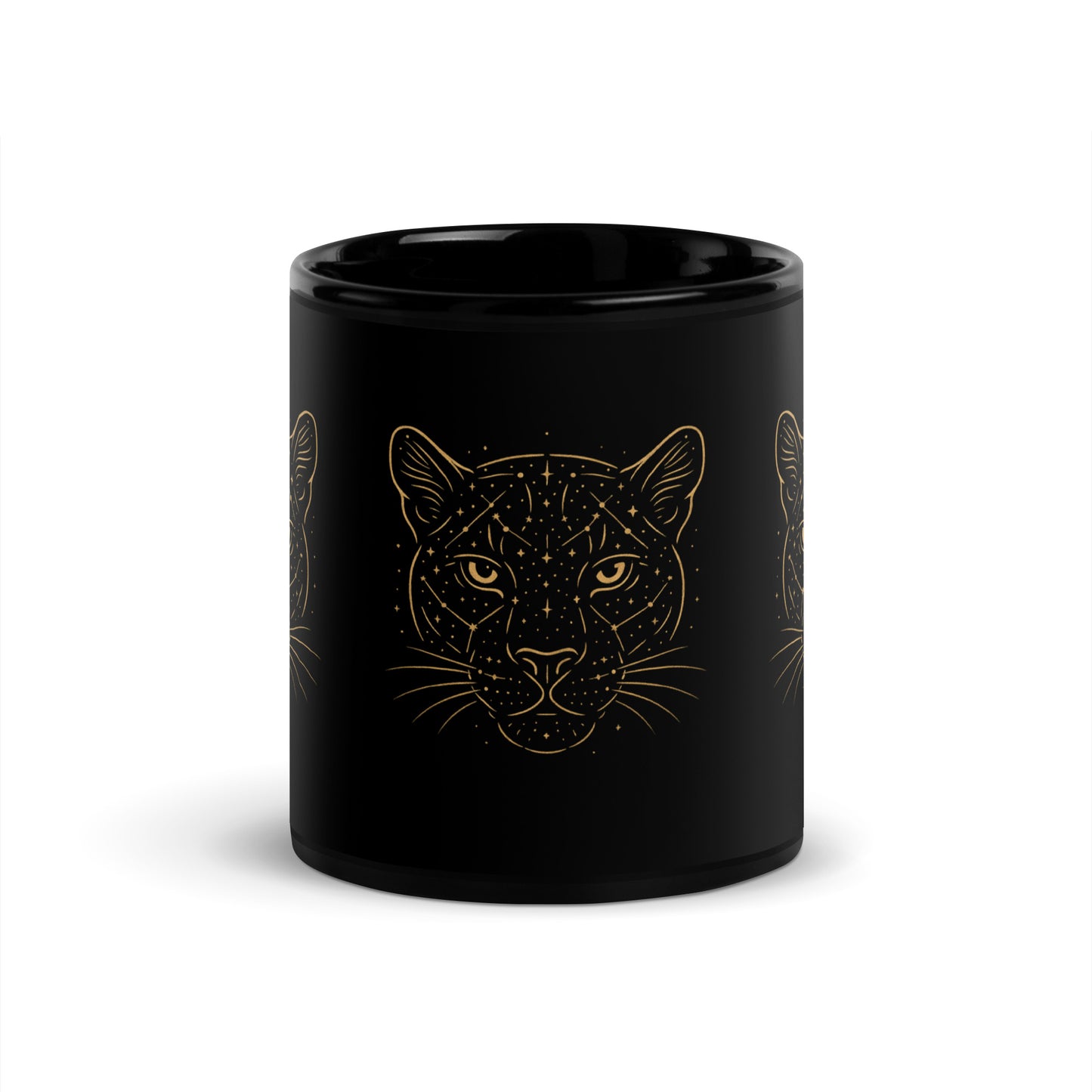 Close-up of the golden Constellations Big Cat design on a black ceramic mug. Center view.