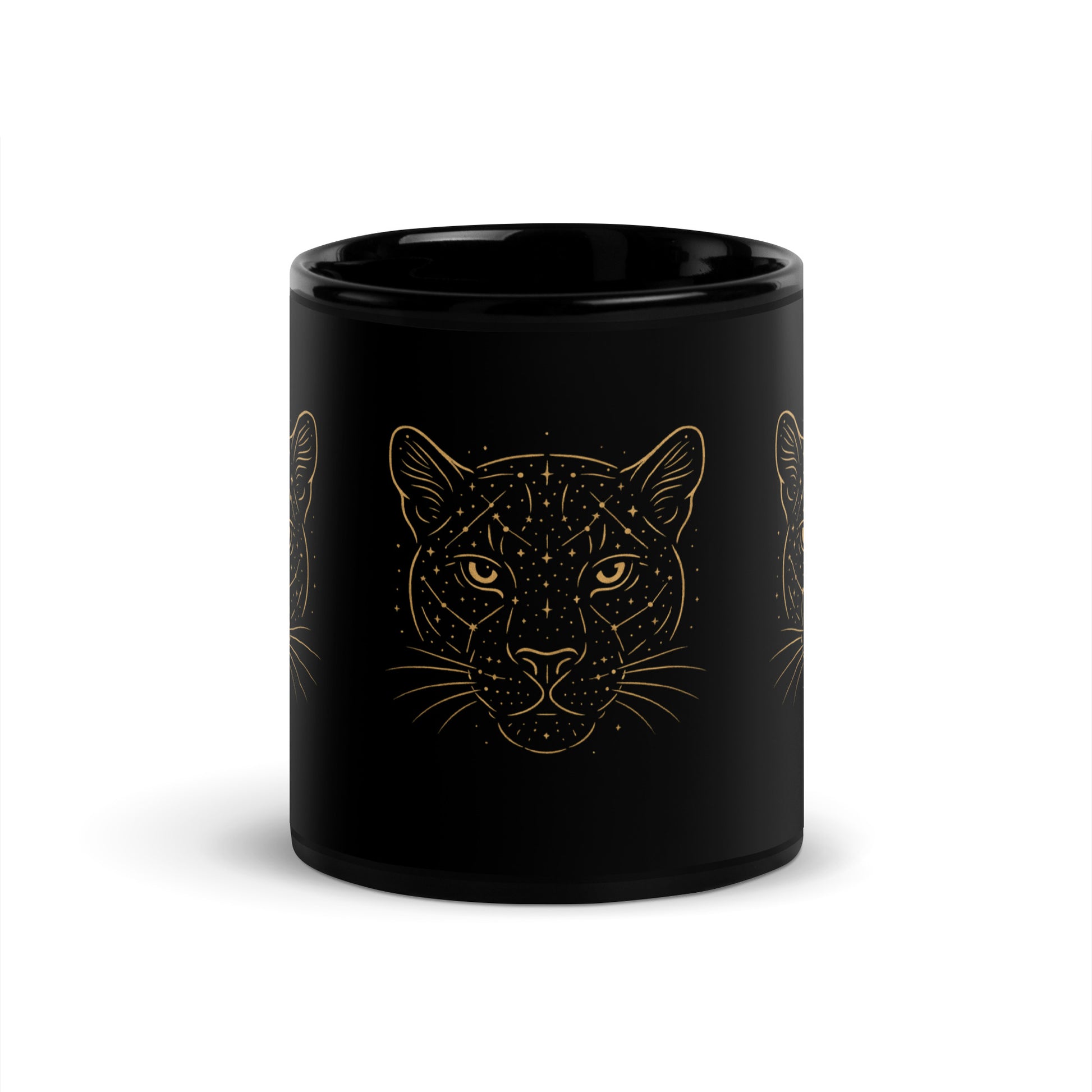 Close-up of the golden Constellations Big Cat design on a black ceramic mug. Center view.
