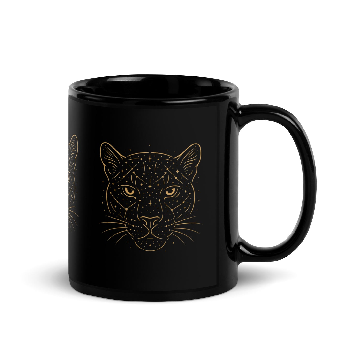Close-up of the golden Constellations Big Cat design on a black ceramic mug.