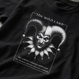 Black t-shirt with a graphic of a jester's face and text on a dark background 